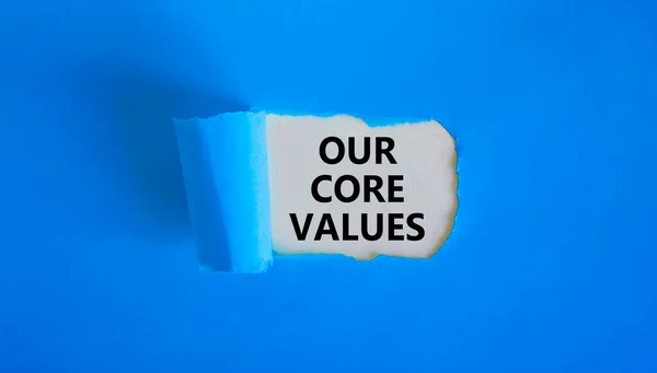 我们的核心价值观象征 我们的核心价值观 一词出现在撕破的蓝皮书后面 漂亮的蓝色背景 我们的核心价值观 复制空间 — 图库照片