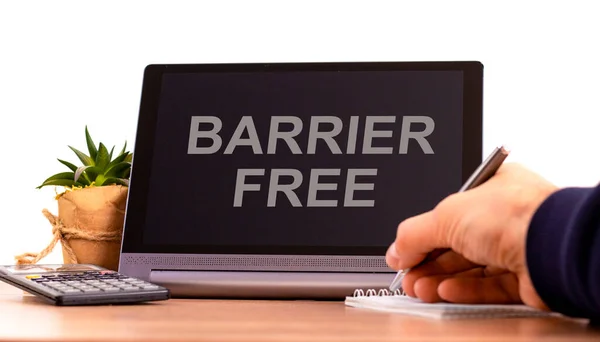 Barrier free symbol. Tablet with words \'barrier free\'. Businessman hand, pen, house plant. Copy space. Beautiful white background. Diversity, inclusion, belonging and barrier free concept, copy space.