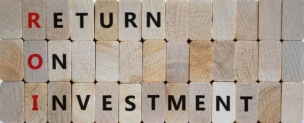 ROI, Return on investment symbol. Wooden blocks with words \'ROI, Return on investment\'. Beautiful wooden background, copy space. Business and ROI, return on investment concept.