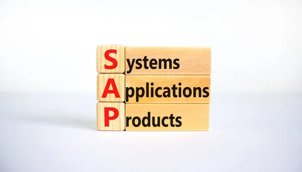 SAP, systems, applications, products symbol. Wooden blocks with words SAP, systems, applications, products. White background, copy space. Business and SAP, systems, applications, products concept.