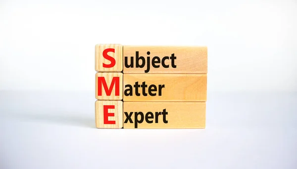 SME, subject matter expert symbol. Concept words SME, subject matter expert on wooden blocks on a beautiful white background. Business, SME, subject matter expert concept. Copy space.