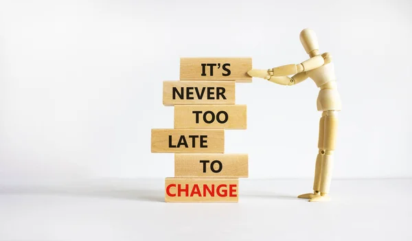 Change symbol. Wooden blocks with words 'It is never too late to change'. Businessman model. Beautiful white background, copy space. Business and It is never too late to change concept.