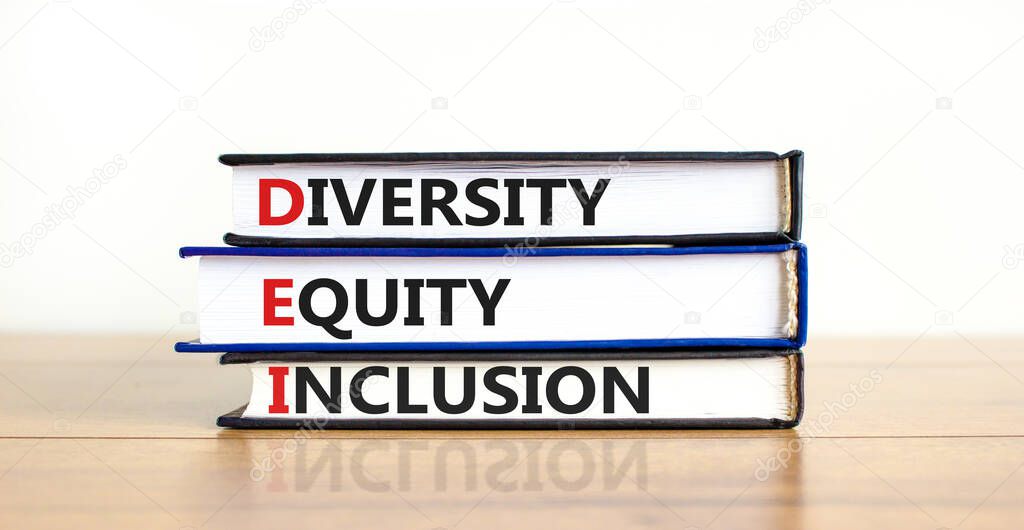 DEI, Diversity, equity, inclusion symbol. Books with words DEI, diversity, equity, inclusion on beautiful wooden table, white background. Business, DEI, diversity, equity, inclusion concept.