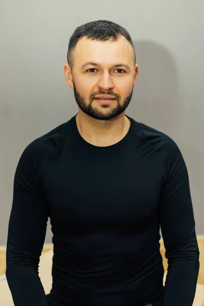 Confident bearded man with crossed hands isolated on gray background.