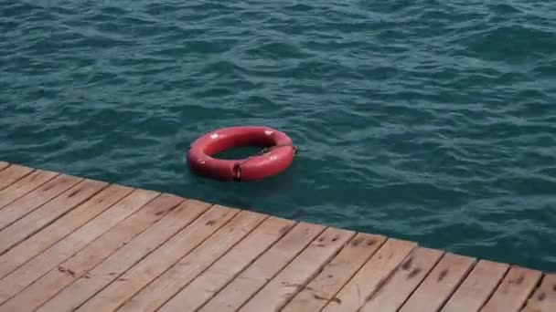 Red Lifebuoy Safety Ring Floating Dock Blue Sea Water Life — 图库视频影像