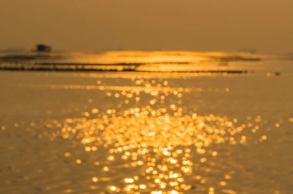 Golden bokeh defocus art abtracts background from sea — Stock Photo, Image