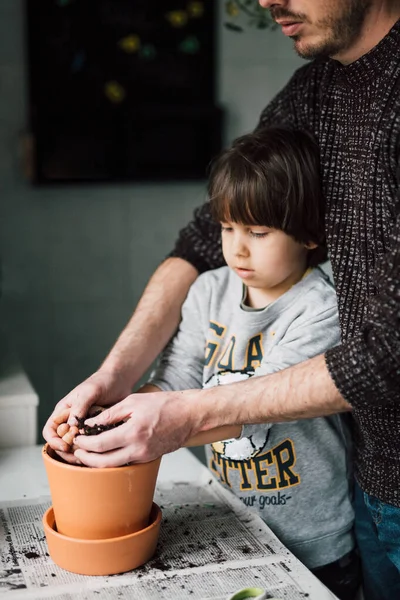 Father Son Planting Seeds Flower Pot Topsoil Home Real Family 免版税图库图片