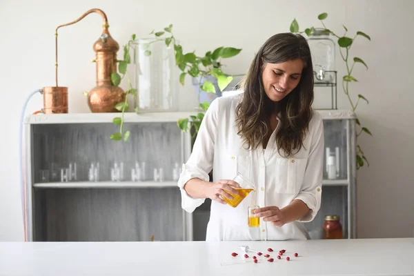 Woman in cosmetic laboratory working with essential oils