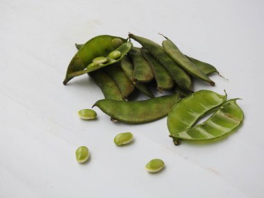 Beyaz arka planda soyulmuş tohumlar olsun ya da olmasın, Hint sümbülü fasulye ya da Avarekai 'nin yakın çekimleri.