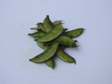 Beyaz arka planda soyulmuş tohumlar olsun ya da olmasın, Hint sümbülü fasulye ya da Avarekai 'nin yakın çekimleri.