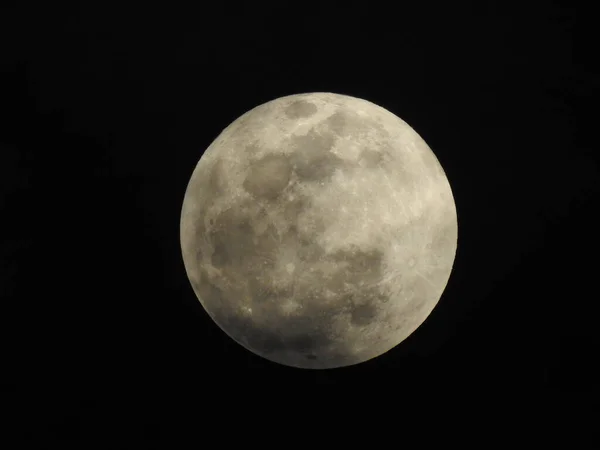 Closeup of Real and Natural Full Moon in the Sky at night at Bangalore, Karnataka, India in a black background