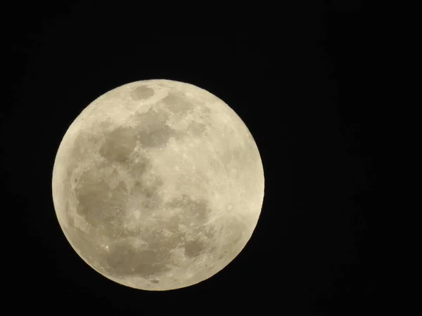 Closeup of Real and Natural Full Moon in the Sky at night at Bangalore, Karnataka, India in a black background