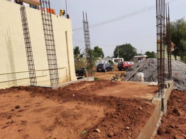 Bangalore, Karnataka, Inida-Apr 23 2021: Temelde konut inşaatı ve toprağının kapatılması, sütun için demir çubuklar