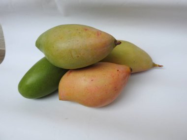 Closeup of single and group of Totapuri Raw Mango Fruit isolated on white background clipart