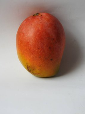 Closeup of beautiful fresh and colorful Indian Alphonso Mango fruits isolated on white background