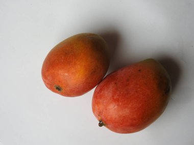 Closeup of beautiful fresh and colorful Indian Alphonso Mango fruits isolated on white background