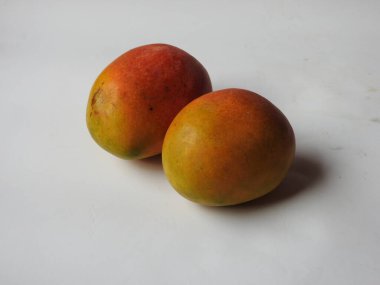 Closeup of beautiful fresh and colorful Indian Alphonso Mango fruits isolated on white background