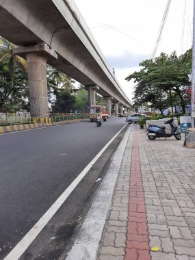 Bangalore, Karnataka, India-Jun 09 2021: Closeup of empty roads due to covid 19 lockdown rules restriction, for transport in a Bangalore, Yelachenahalli Metro Station Road looks beautiful and clean