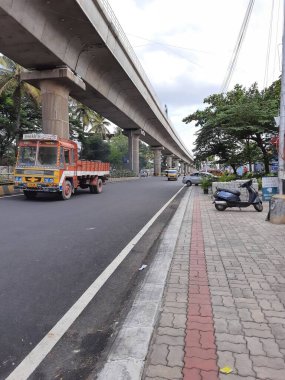 Bangalore, Karnataka, India-Jun 09 2021: Closeup of empty roads due to covid 19 lockdown rules restriction, for transport in a Bangalore, Yelachenahalli Metro Station Road looks beautiful and clean