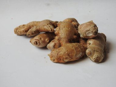 Group of Spice and Medicinal Fresh ginger rhizome with green leaves isolated on white background.