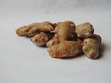 Group of Spice and Medicinal Fresh ginger rhizome with green leaves isolated on white background.