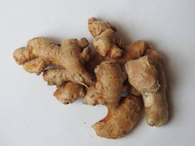Group of Spice and Medicinal Fresh ginger rhizome with green leaves isolated on white background.