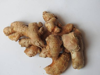 Group of Spice and Medicinal Fresh ginger rhizome with green leaves isolated on white background.