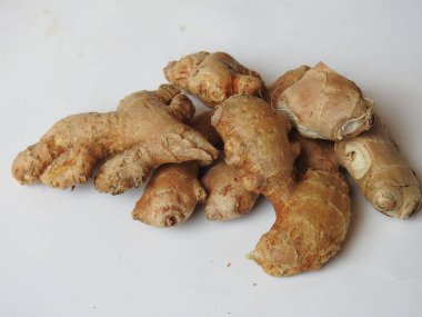 Group of Spice and Medicinal Fresh ginger rhizome with green leaves isolated on white background.