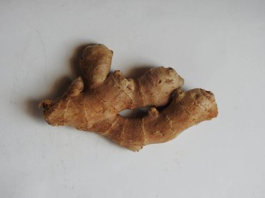 Group of Spice and Medicinal Fresh ginger rhizome with green leaves isolated on white background.