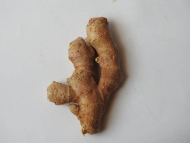 Group of Spice and Medicinal Fresh ginger rhizome with green leaves isolated on white background.