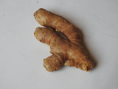 Group of Spice and Medicinal Fresh ginger rhizome with green leaves isolated on white background.
