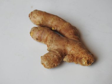 Group of Spice and Medicinal Fresh ginger rhizome with green leaves isolated on white background.