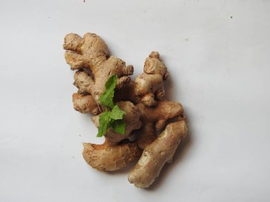 Group of Spice and Medicinal Fresh ginger rhizome with green leaves isolated on white background.