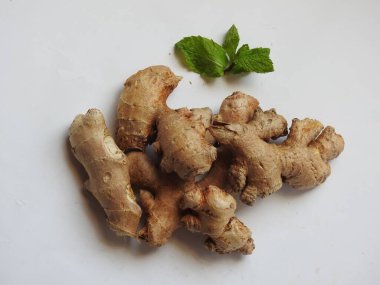 Group of Spice and Medicinal Fresh ginger rhizome with green leaves isolated on white background.