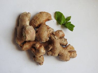 Group of Spice and Medicinal Fresh ginger rhizome with green leaves isolated on white background.
