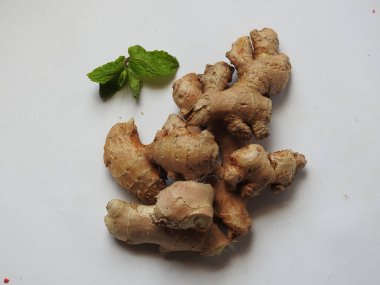 Group of Spice and Medicinal Fresh ginger rhizome with green leaves isolated on white background.