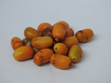 Closeup of Golden Yellow Color young and raw Zehidi Dates with seeds isolated on white background