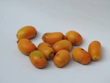 Closeup of Golden Yellow Color young and raw Zehidi Dates with seeds isolated on white background