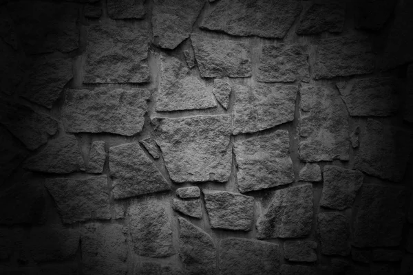 Black wall with textured stone blocks — Stock Photo, Image