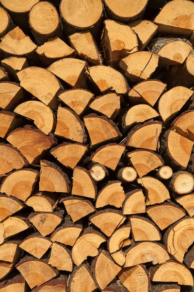 Stacked chopped wood for the winter or construction as background — Stock Photo, Image
