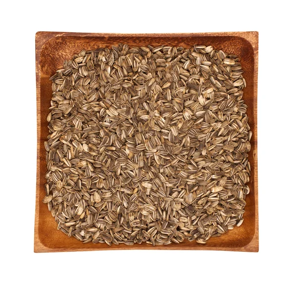 Nasiona słonecznika w drewniana miska na białym tle — Zdjęcie stockowe