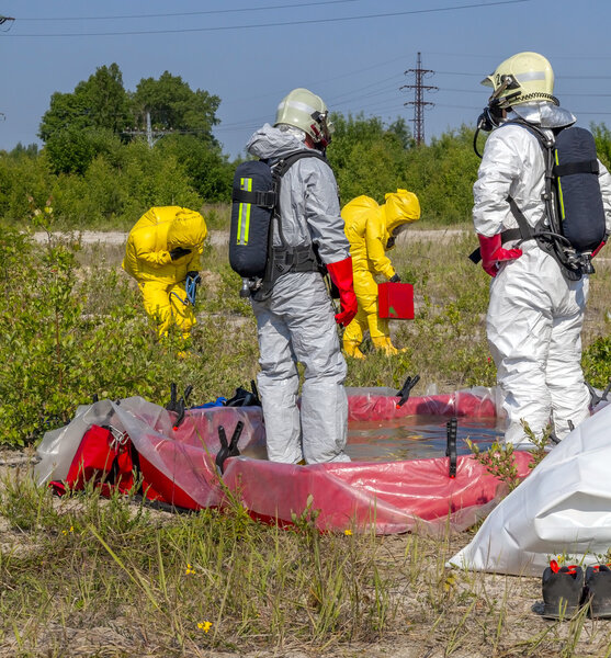Hazmat team members have been wearing protective suits to protect them from hazardous materials