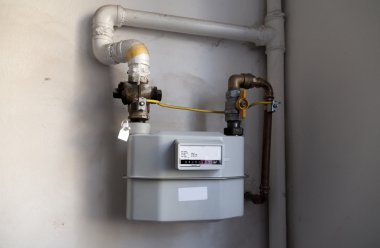 Gas meter on the white wall clipart