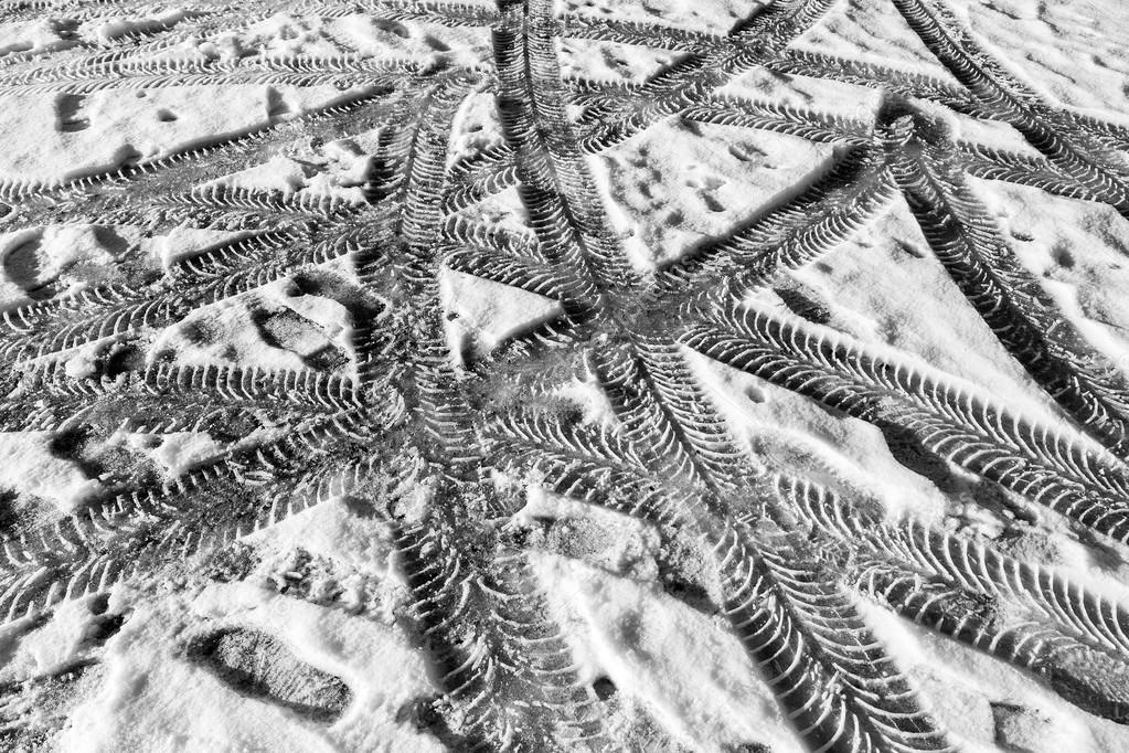 Tracks of car tires in thin layer of first snow