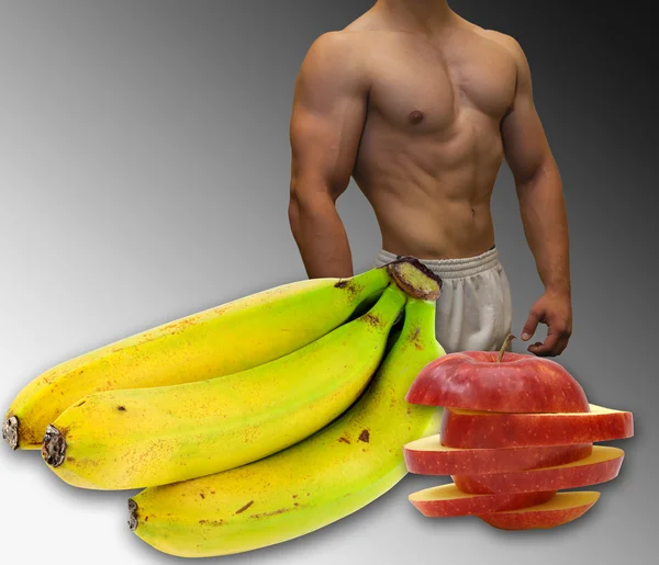 Imagem de um ajuste, corpo muscular, frutas — Fotografia de Stock