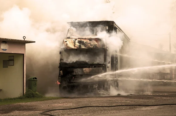 Fire and black smoke on the road after a truck collision — Stock Photo, Image