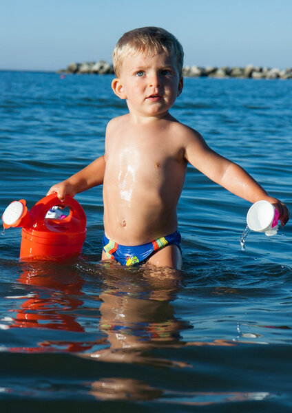 child playing in the sea