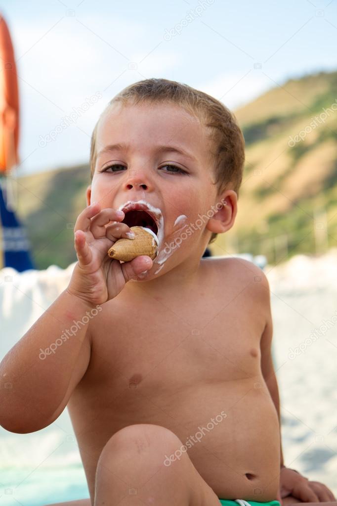 Baby, eating an ice cream on the beach
