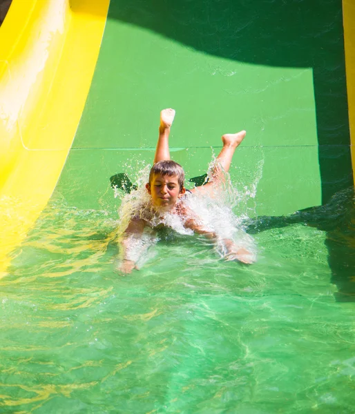 Child playing on water slide — Stock Photo, Image