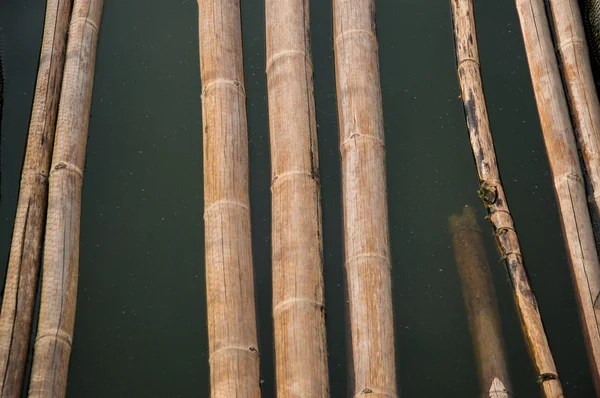 Bamboo stick walkpath in dirty turbid water — Stock Photo, Image
